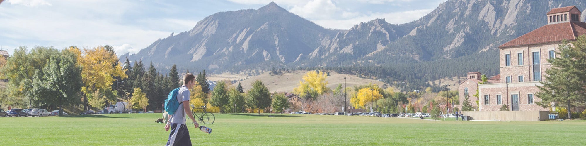 Student walking in front of the flatirons