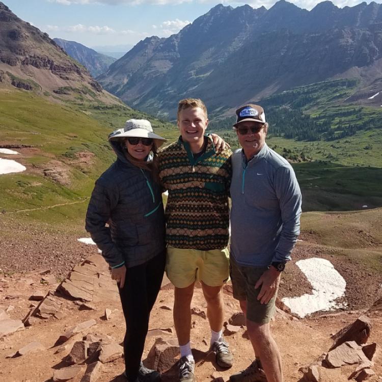The Smith family standing in front of mountains