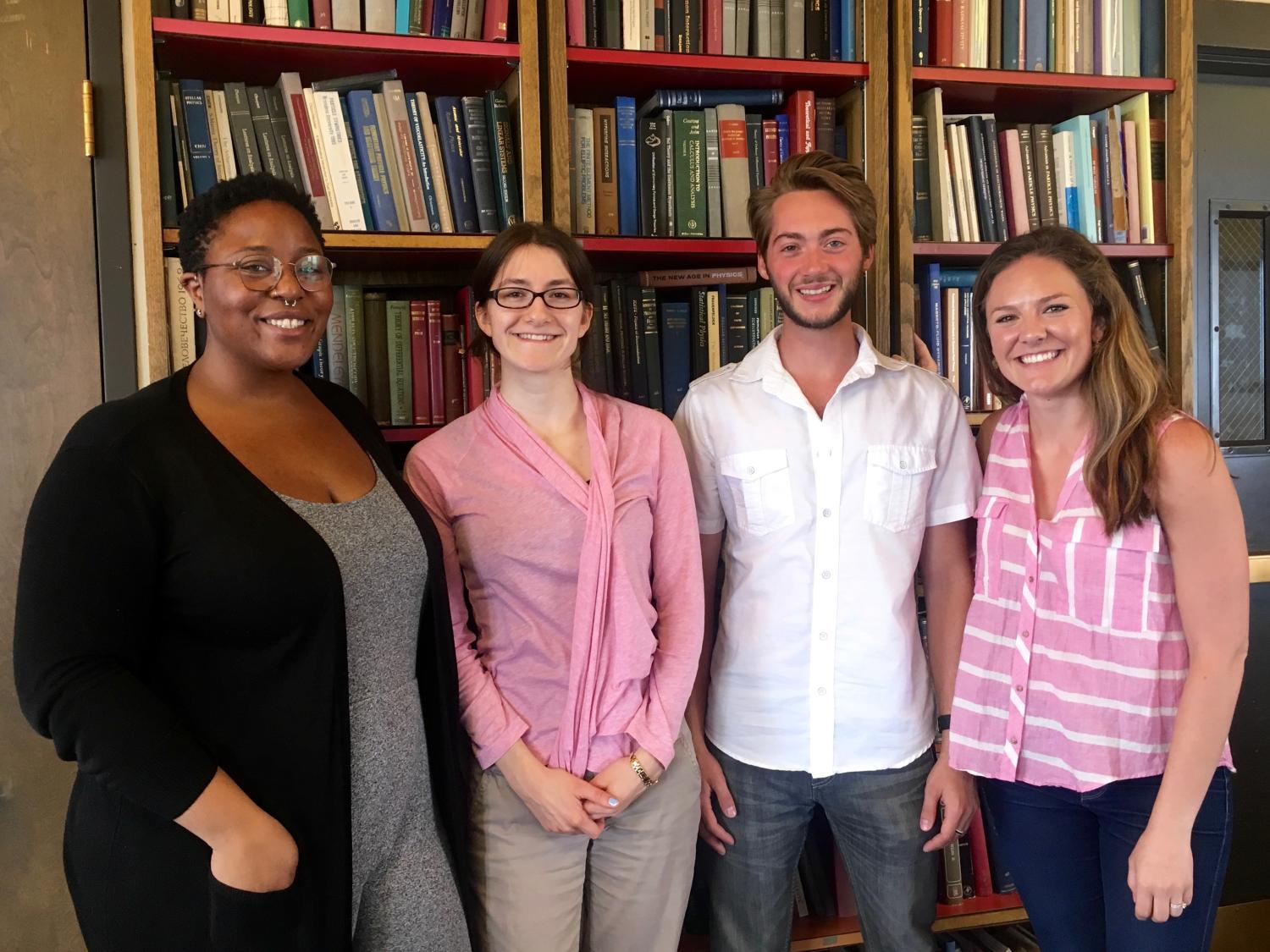 Simone Hyater-Adams, Allie Lau, Julian Gifford, Jessica Hoehn standing in front of bookshelves
