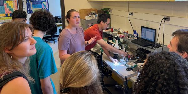 Students learning how to use lab equipment