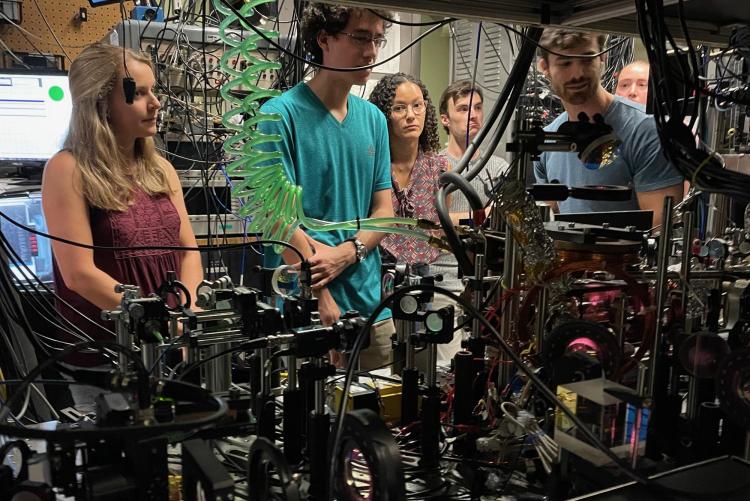Students looking at equipment in the Ye Lab