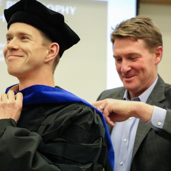 PhD Candidate Daniel Cole being hooded.