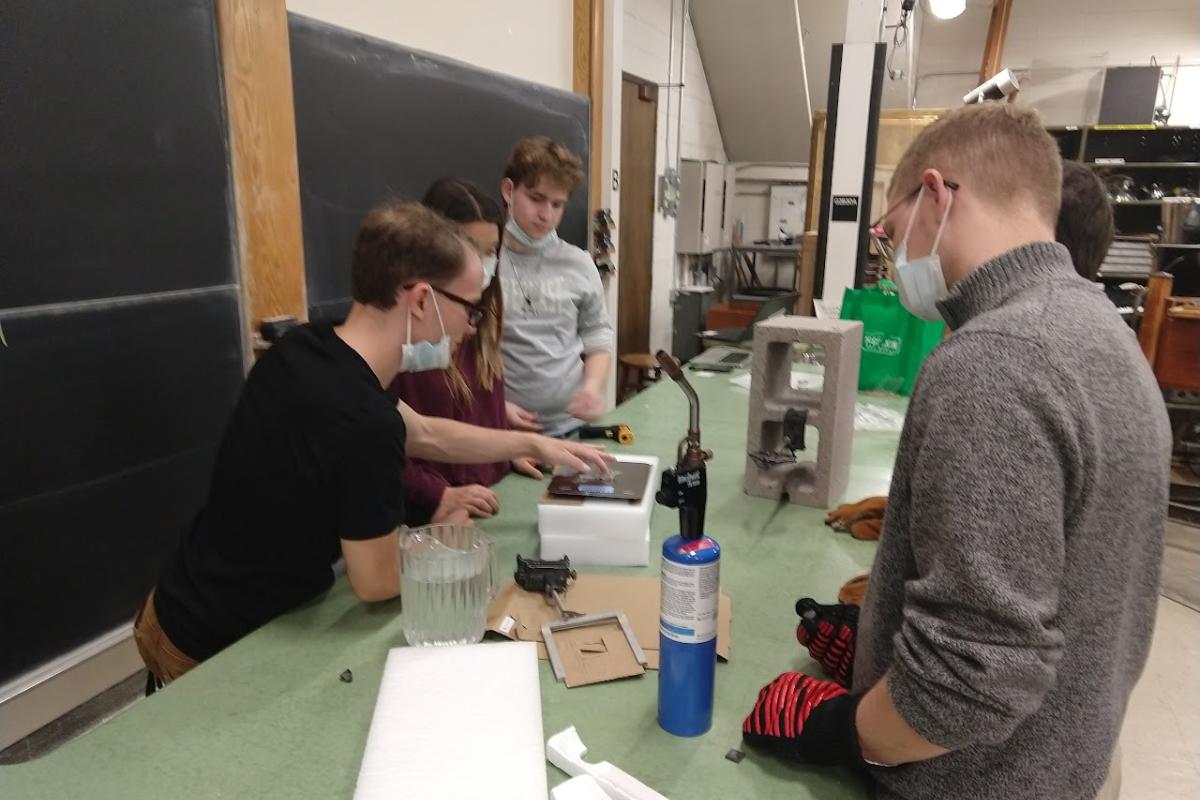 Students looking at an experiment in the lab