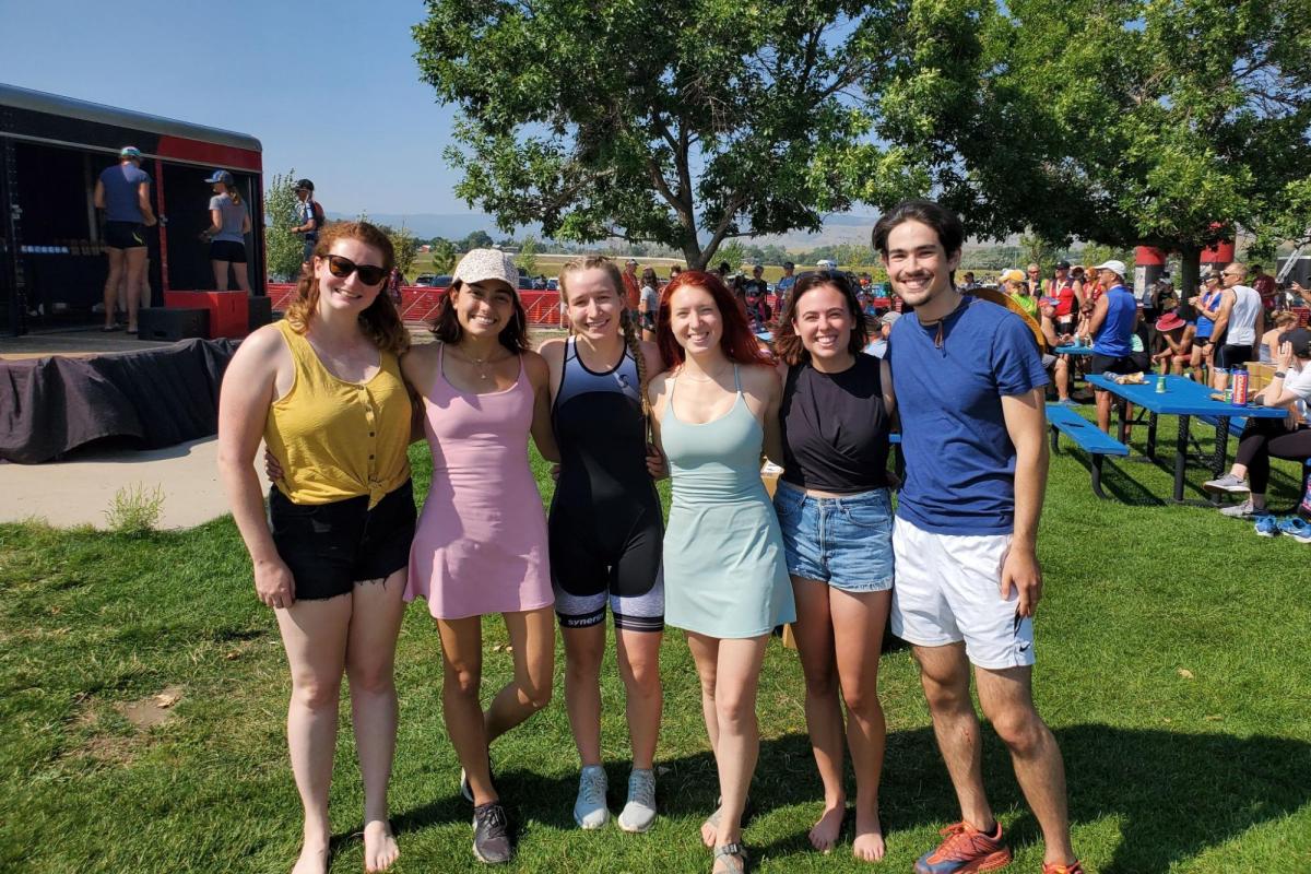 People posing and smiling in an open field