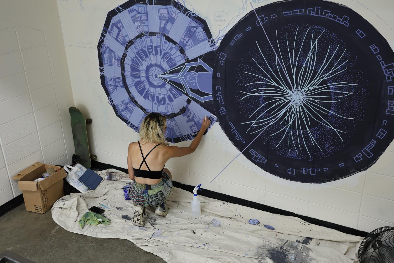 Veronica Keff painting a mural