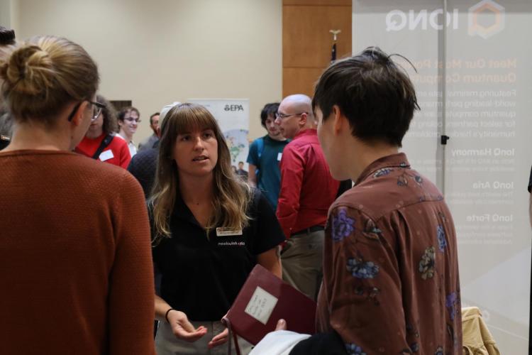 An employer talks with students at the career fair