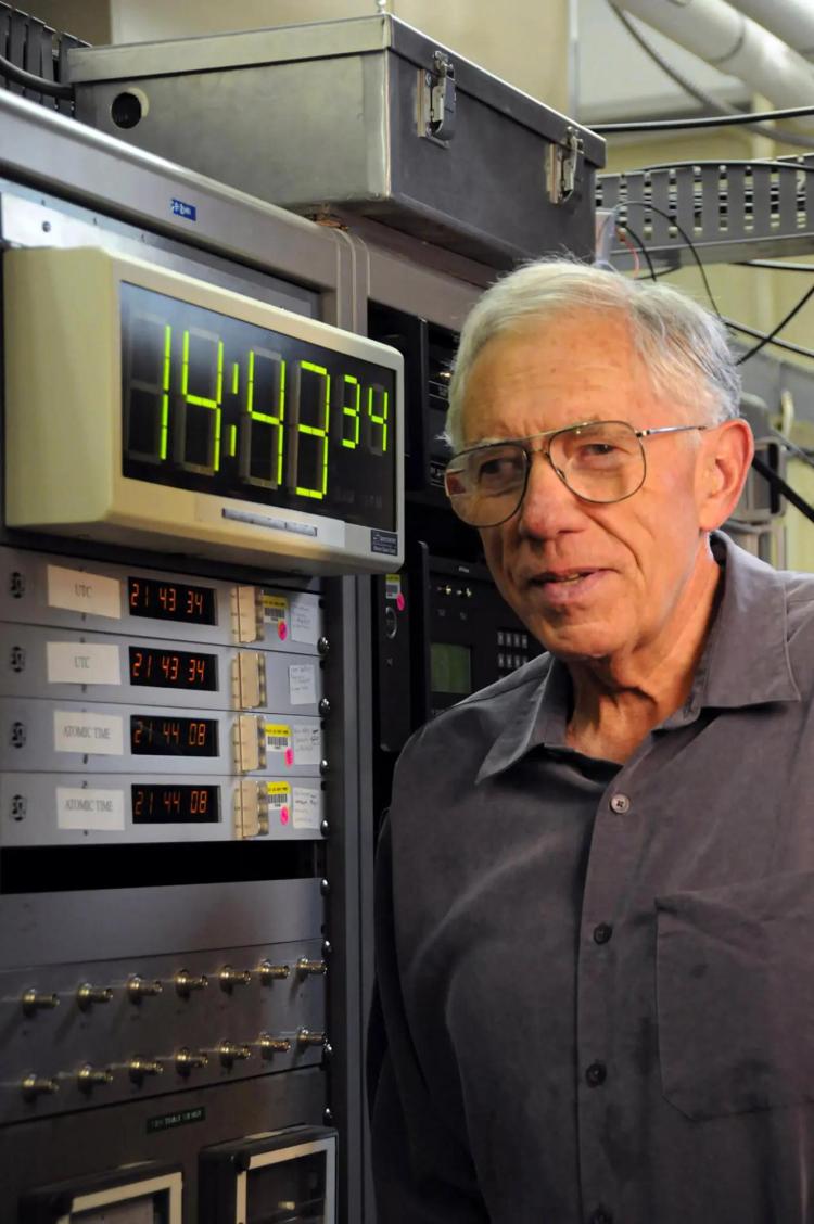 Judah Levine pictured in front of a clock
