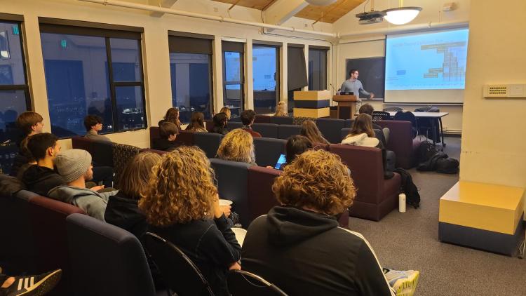 Students listening to a research talk at the Society of Physics Students meeting