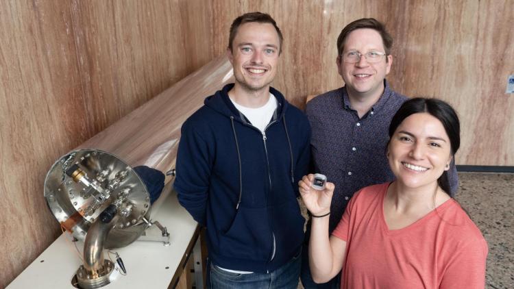 Alexander Staron, William McGehee, and Gabriela Martinez pictured with the chip-scale atomic beam clock.
