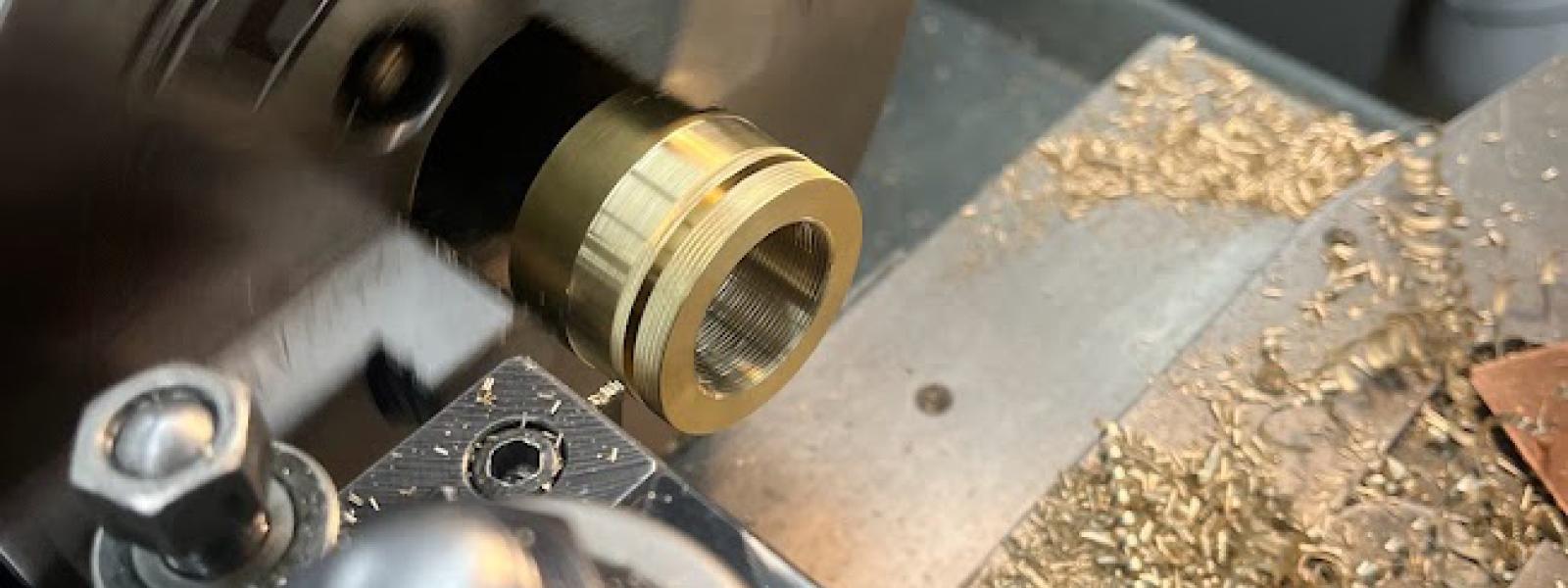 A lathe turning brass