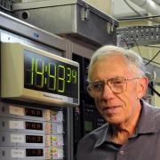 Judah Levine pictured in front of a clock