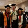 Three graduating students smiling