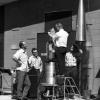 A rocket pointing control unit being checked by four Ball Brothers staff, 1965. Courtesy of Boulder Historical Society.