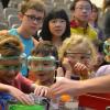 Children watching a science experiment during a CU Wizards show