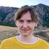 Portrait of Cindy Regal standing in front of the Flatirons in Boulder