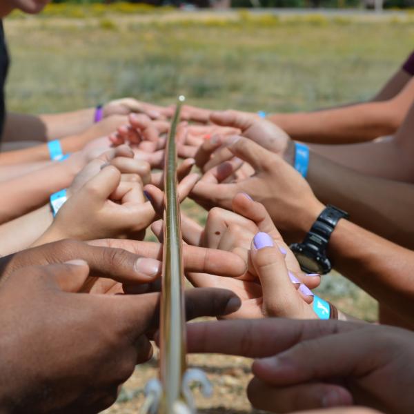 Students learn teamwork and use critical thinking to problem solve at one of the stations at orientation