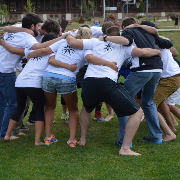 The student staff huddle up to talk kick-ball strategy versus the first-year team
