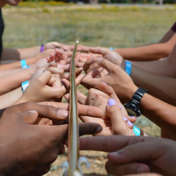 Students learn teamwork and use critical thinking to problem solve at one of the stations at orientation