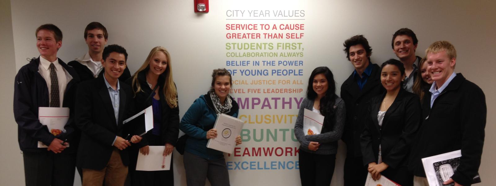 PLC students stand in front of the City Year Values wall art during Education Weekend