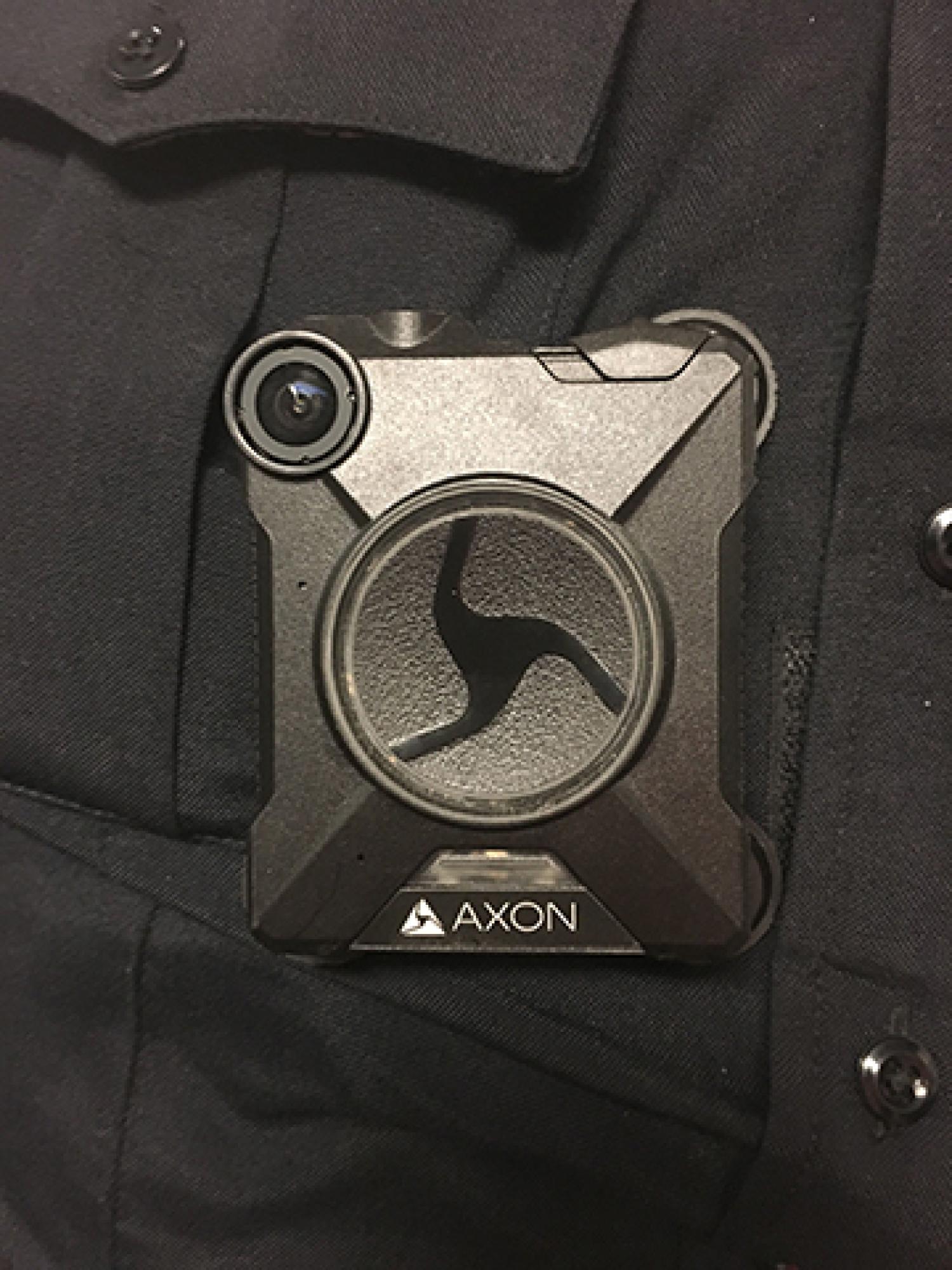 An Axon body-worn camera worn by a officer