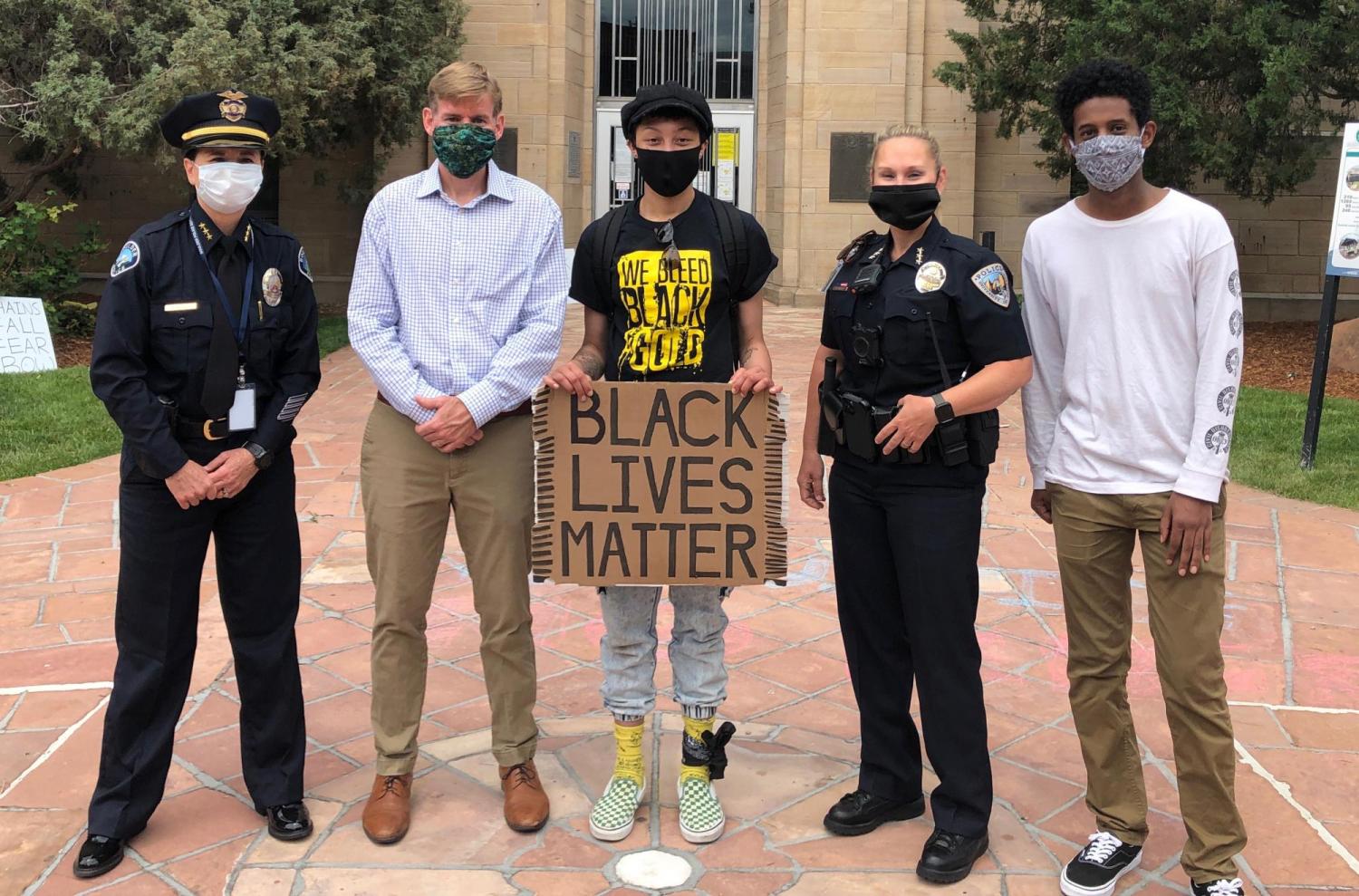 Chief Jokerst stands with CU students Kennedy Blackwell and Jemil Kassahun as well as the Boulder DA Michael Dougherty and Boulder police chief Maris Herold at a Black Lives Matter march in the summer of 2020.