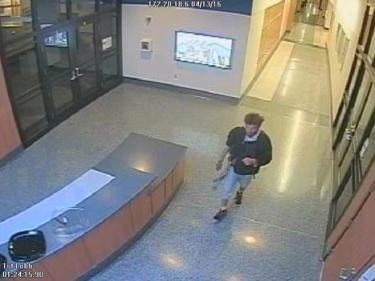 Screen capture of the arson suspect as he walks through the building