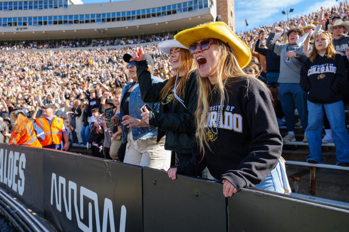 Student cheering at football game (link to prospective student info)