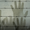 Hands reaching over barbed wire (stylized) 