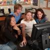 four women at a computer