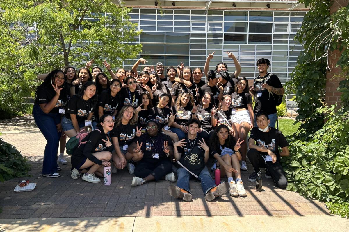 Precollege students posing outside.