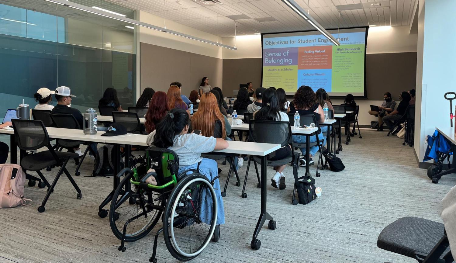 Precollege students in a classroom attending a presentation.