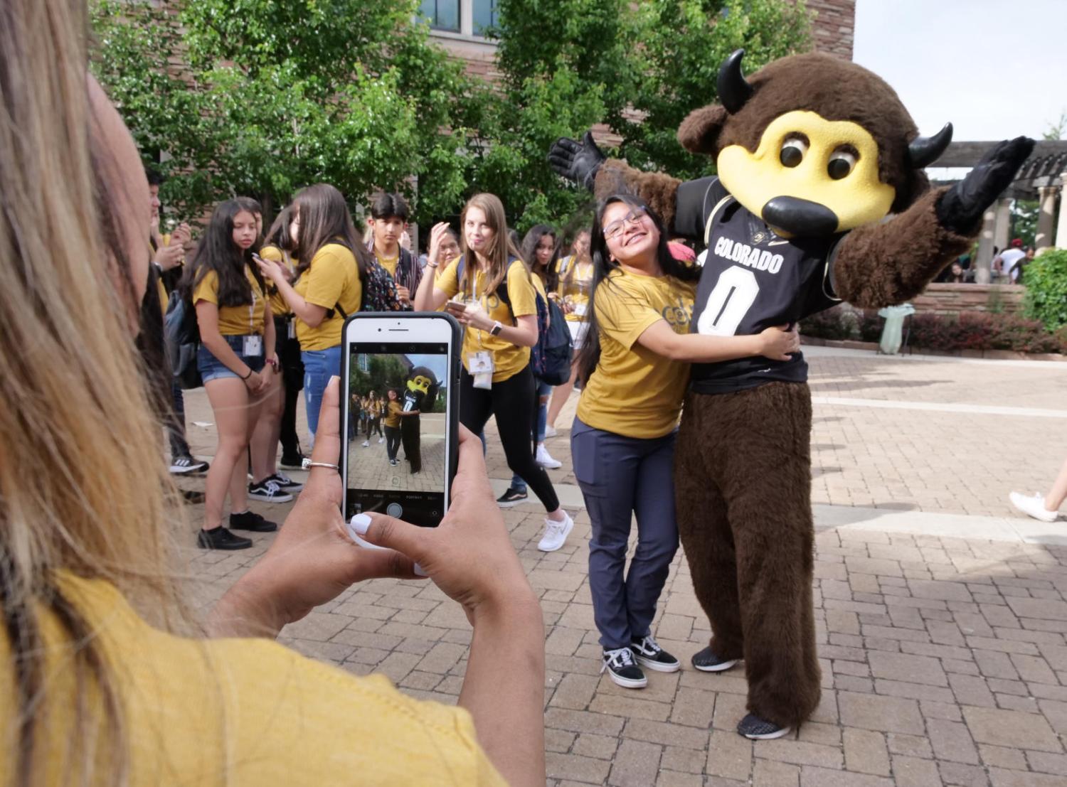 Chip with students taking photo