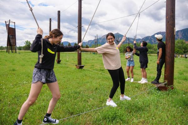 PCDP Bridge students working together on a ropes course