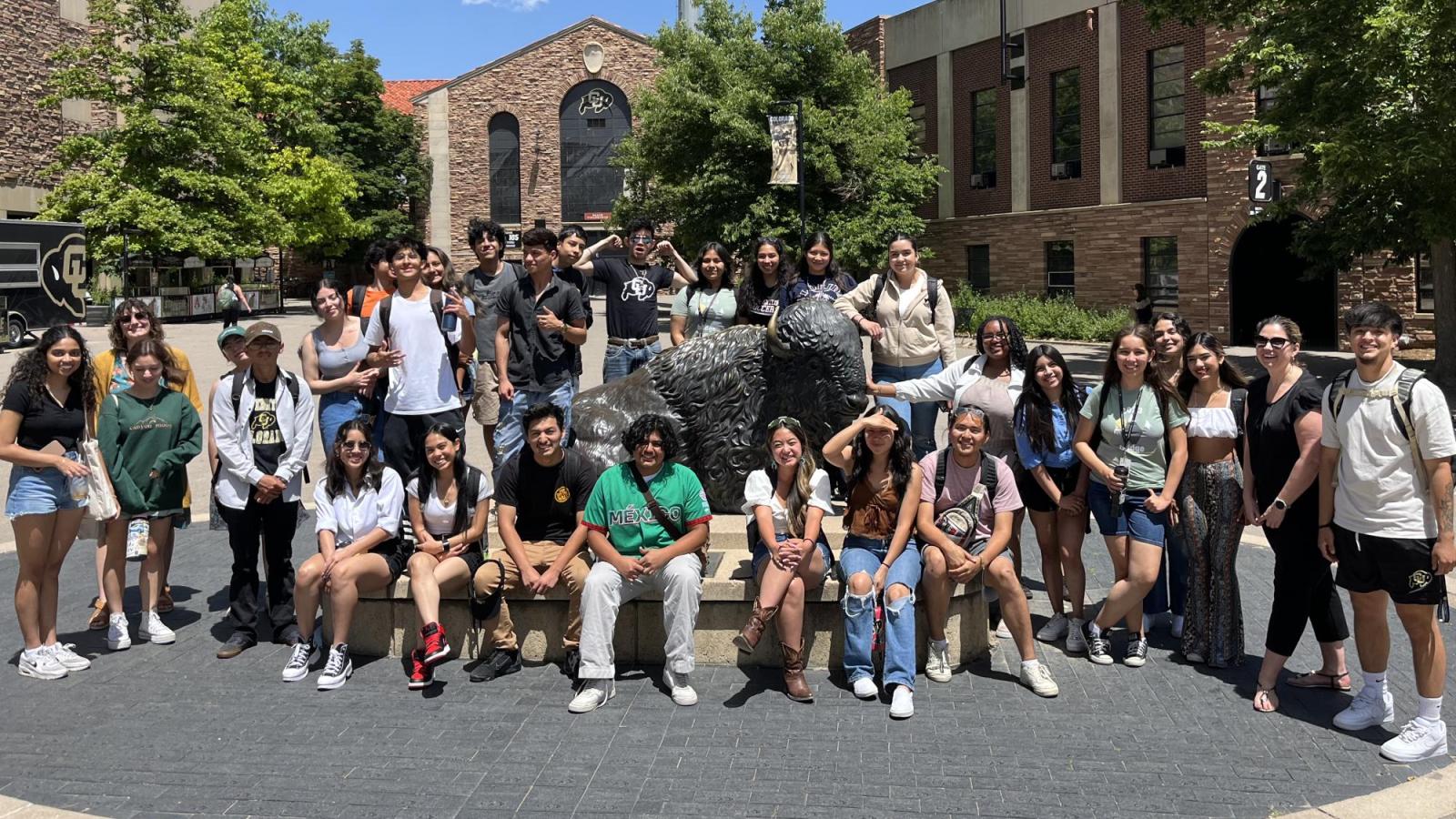Precollege students posing in front of Folsom Field.