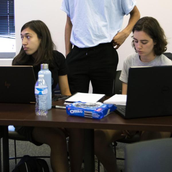 Teaching assistant Nathaniel Nash listens as Professor Michael Stoner gives instructions to the class.