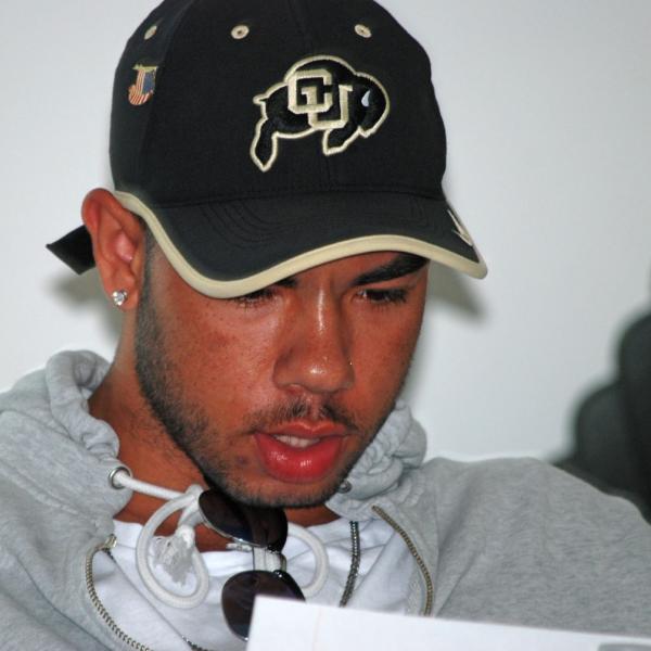Darrion Pyos reads up on NCAA student-athlete stipends. (Photo by Murray Meetze/University of Colorado)