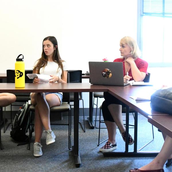 Devon Goodwin and Lauren Irwin talk with their group leader, Emilee Johnson, about body shaming.