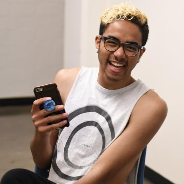 Teaching assistant and residential assistant Nathaniel Nash smiles for a photo while waiting to take the Pathways students to their next session.