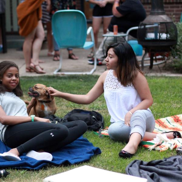 Jacqueline Lee and Alina Naomi playing with Voakes’ dog, Lucy