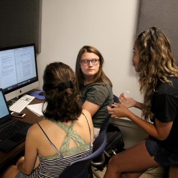 Aabriti Shrestha explains a project idea to Bella Liffick and Emma Baziuk during a DCMP session.