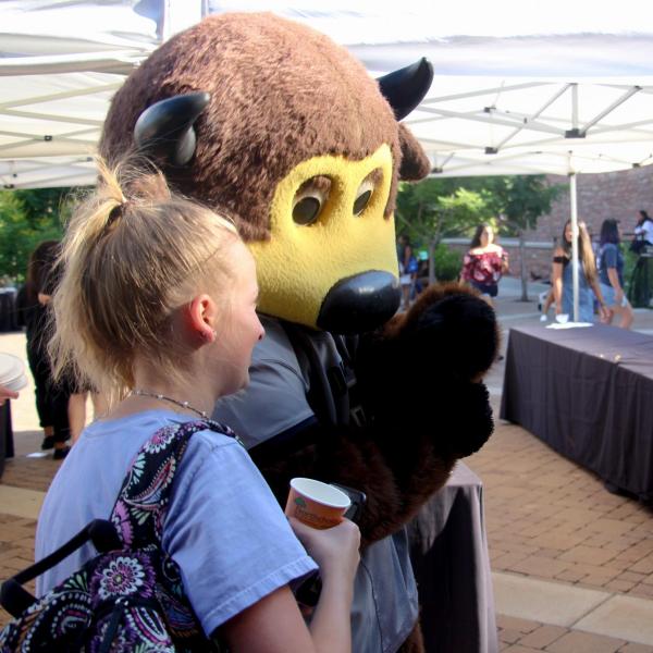 Devon Goodwin (left), Kate Robinson (middle) and Lauren Irwin (right) talk with Chip at a picnic.