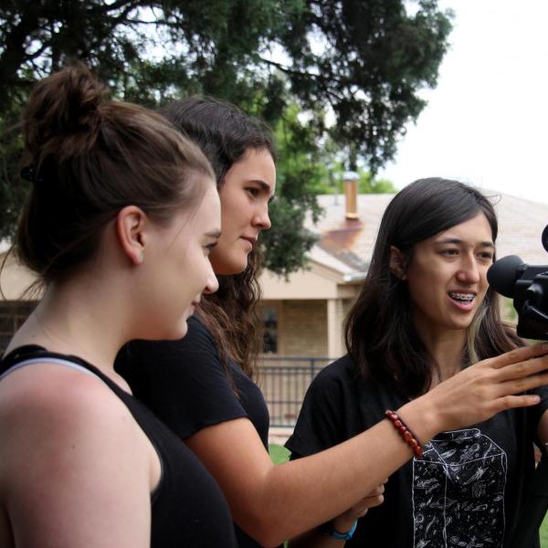 Talia Berlin adjusts the zoom on her group's camera.