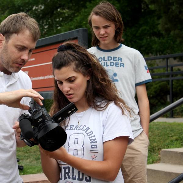 Instructor Pat Clark helps Kate Robinson adjust the settings on her camera.