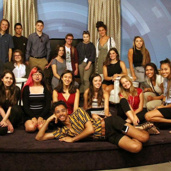 Students and peer mentors pose for a photo on one of the stages at CBS4.