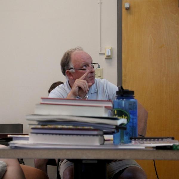 Professor Michael Stoner looks over a project with two students.