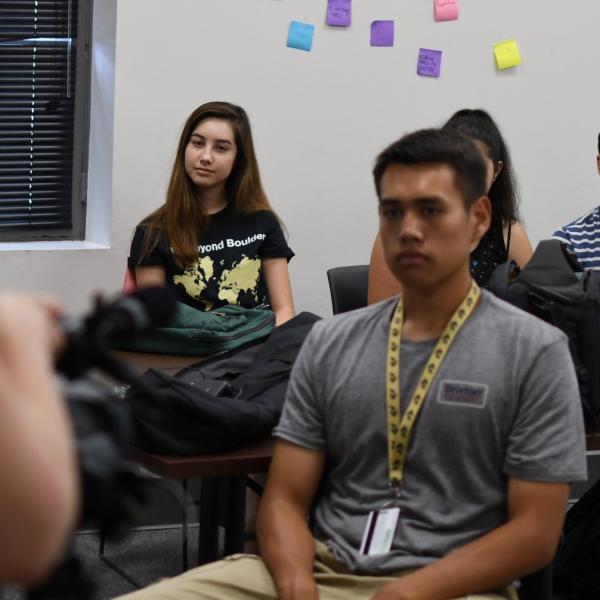 Nina Ryan listens as Emilie Johnson shows the Pathways participants how the cameras work.