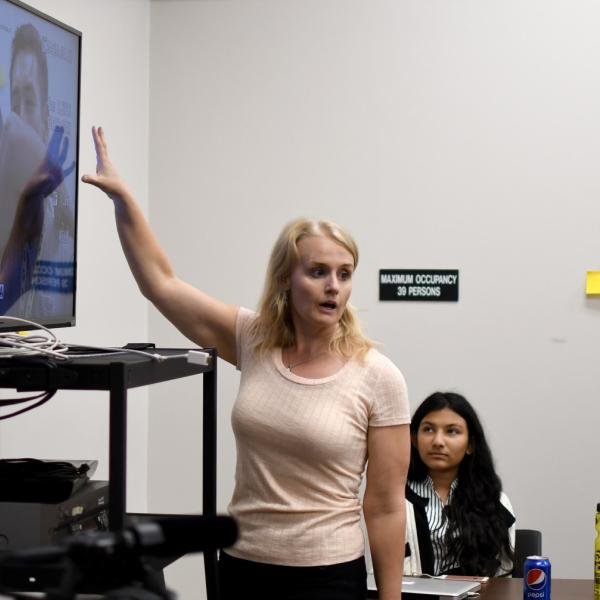 Emilie Johnson shows the Pathways participants how the cameras work.