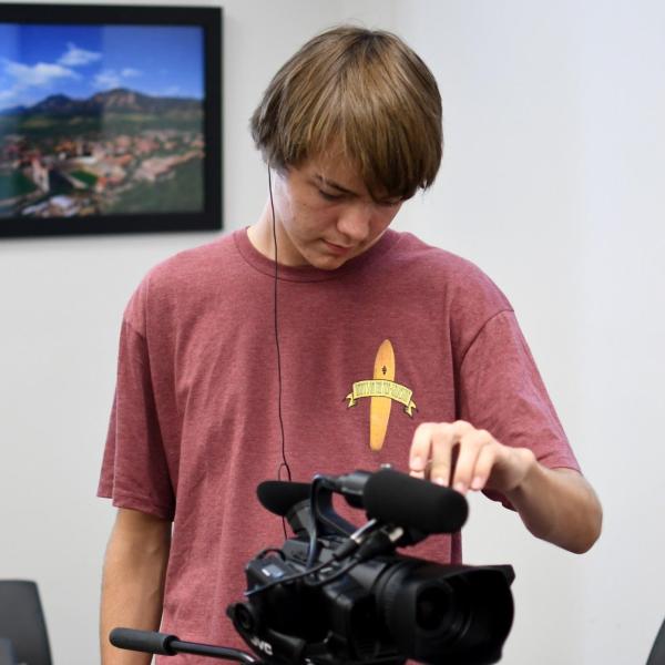 Conner Davis sets up the camera for an interview with one of his classmates.