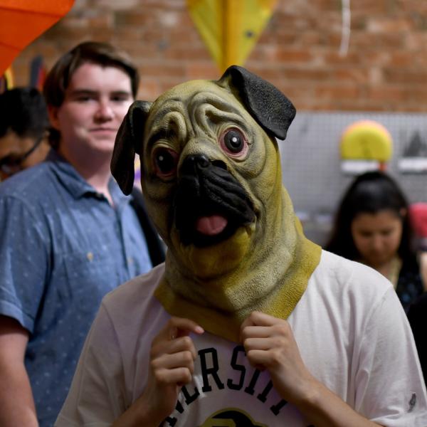 Stephen Callcott tries on a dog mask at a toy store on Pearl Street.