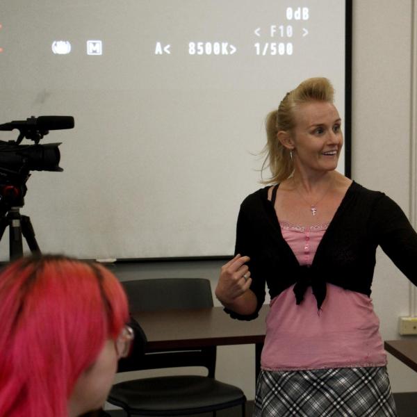 Instructor Emilee Johnson explains features of the video camera to the class.